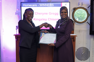 Cllr Naima Ali presenting a certificate to Cheryne Gregg